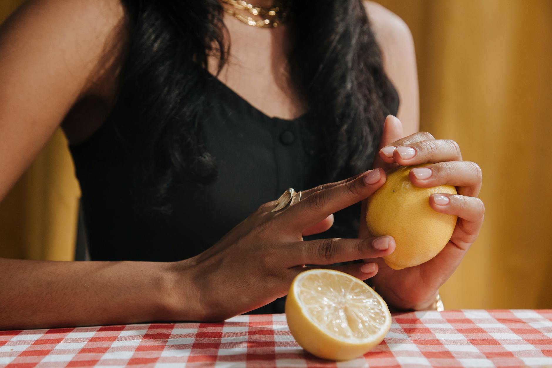 Woman holding blue and pink silicone vibrators in a thoughtful, intentional way